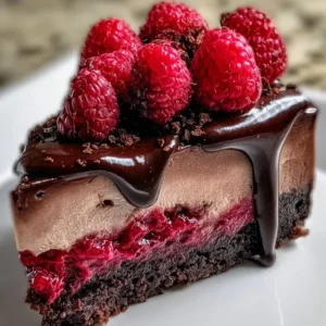 Decadent dark chocolate raspberry cheesecake topped with fresh raspberries
